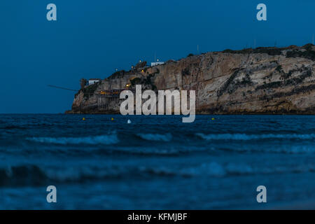 The rocky headlands of Peschici, Italy dotted with traditional fishing towers called trabucco, Gargano National Park, Puglia. Stock Photo