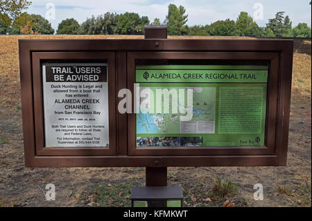 sign posted Duck hunting advisory and map at Alameda Creek Regional Trail, California Stock Photo