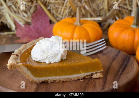 Slice of pumpkin pie with whipped cream topping Stock Photo