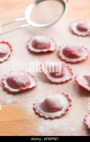 Tasty beetroot ravioli with flour. Stock Photo