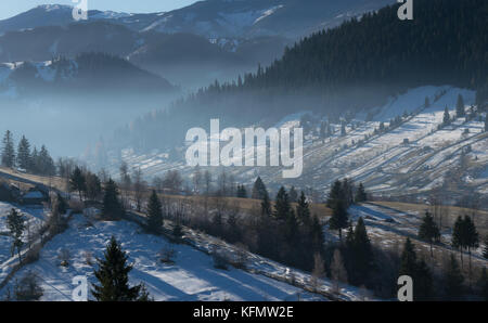 Eastern european winter landscape in a small Romanian mountain village Stock Photo
