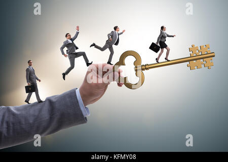 Business people chasing each other towards key to success Stock Photo