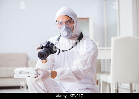 Forensic expert at crime scene doing investigation Stock Photo