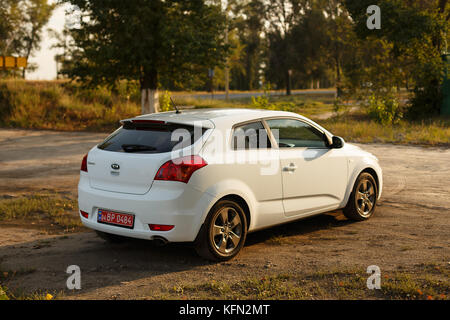 DNIPRO, UKRAINE - SEPTEMBER 05, 2017: KIA CEED WHITE COLOR NEAR THE ROAD IN THE DNIPRO CITY Stock Photo