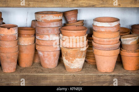 Teracotta pots stacked in a garden shed. Stock Photo