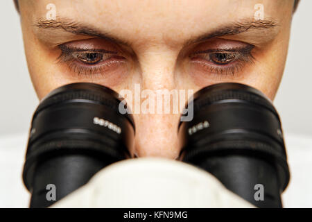 Scientist using a Microscope, Close Up. Stock Photo