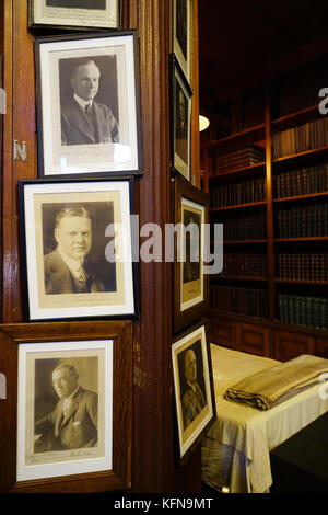 Thomas Edison's napping bed with signed photos of US presidents in his library in Thomas Edison National Historical Park.West Orange.New Jersey.USA