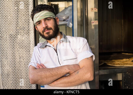 Tehran, IRAN - August 16, 2017 Bakery worker portrait standing in front of bakery shop. Stock Photo