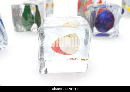 Apple in ice cube isolated on white with depth of field effects. Ice cubes with fresh berries. Berries fruits frozen in ice cubes, 3D rendering Stock Photo