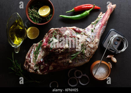 Raw lamb leg, marinated with herbs Stock Photo