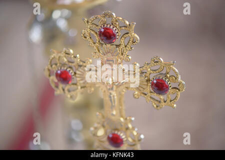 Ornate golden Orthodox cross, a dominant symbol for the Christian faith, in a Romanian church, Brasov, Romania Stock Photo