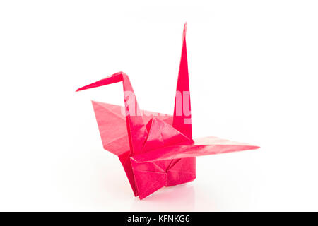 Red Origami Crane Isolated on Blue. Stock Photo