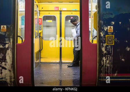 Man standing alone on train Stock Photo