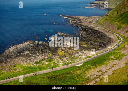 Thousands of tourists visiting Giant's Causeway in County Antrim of Northern Ireland, a World Heritage Site by UNESCO containing about 40000 interlock Stock Photo