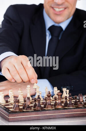 Portrait of a mature businessman playing chess Stock Photo