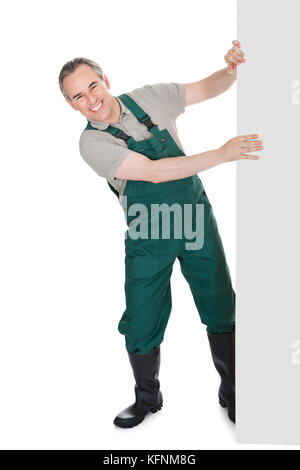 Happy mature gardener presenting empty banner isolated on white background Stock Photo