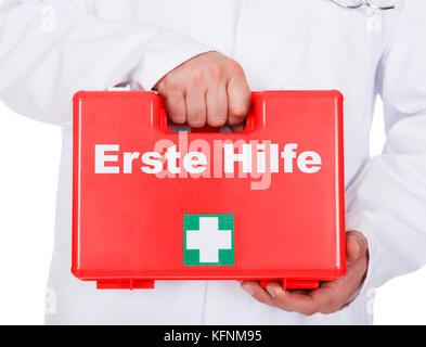 Doctor carrying a portable first aid kit on white background Stock Photo
