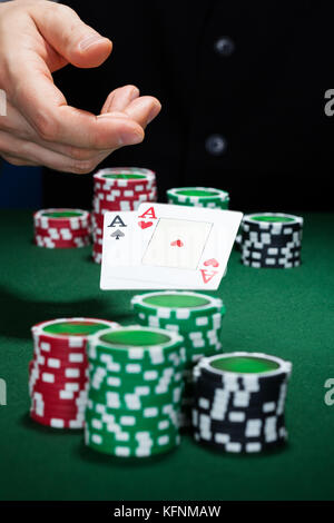 Close-up of hand with playing cards and gambling chips Stock Photo