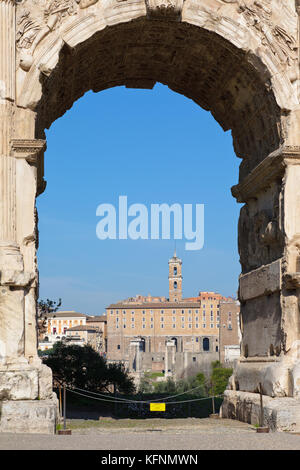 Roman Forum (Latin: Forum Romanum, Italian: Foro Romano) seen through the Arch of Titus (Italian: Arco di Tito; Latin: Arcus Titi), Rome, Italy Stock Photo