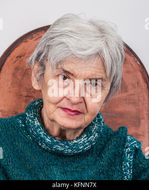 Portrait on a wrinkled old woman looking to the camera. Stock Photo