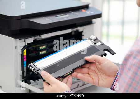 Man replacing toner in laser printer. toner printer cartridge print laser office supplies refill concept Stock Photo