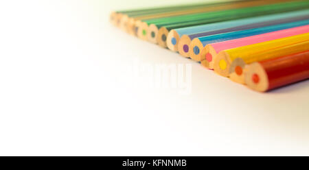 Colored Pencils placed on top right, isolated Stock Photo