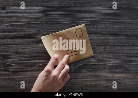 hand picking up unadressed letter Stock Photo