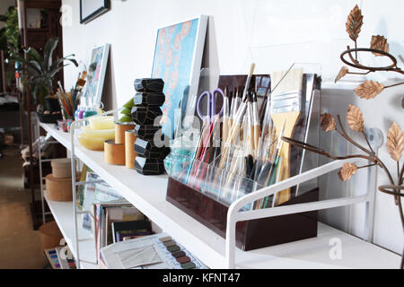 a lot of art tools put on the shelf in artist studio Stock Photo