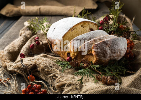 stollen on a wooden table, wrapped in burlap Stock Photo