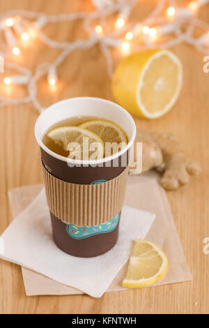 Tea with lemon and ginger in a paper cup Stock Photo