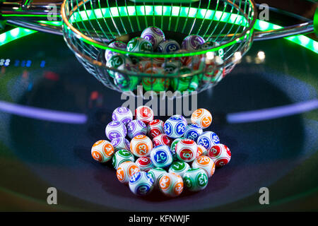 Colourful lottery balls in a rotating bingo machine. Stock Photo