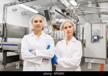 happy women technologists at ice cream factory Stock Photo
