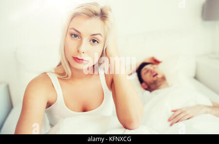 awake woman having insomnia in bed Stock Photo