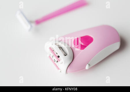 epilator and safety razor on white background Stock Photo