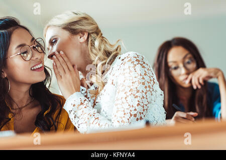 student girls gossiping in class Stock Photo