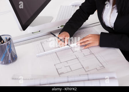Closeup Of Female Architect's Hands Making Blueprints Stock Photo