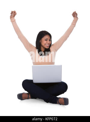 Portrait Of Excited Happy Young Woman Using Laptop Over White Background Stock Photo