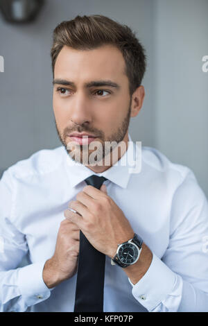 businessman straightening tie  Stock Photo