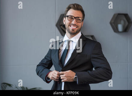 businessman putting on blazer Stock Photo