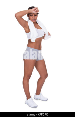 Tired Fitness Woman Wiping Sweat Over White Background Stock Photo