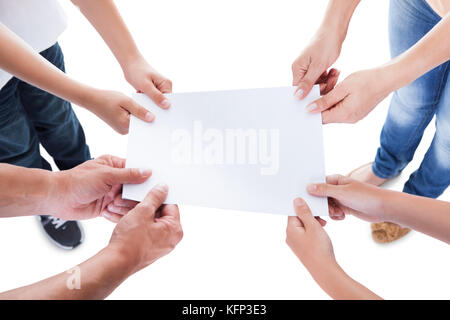 Elevated View Of Family With Two Children Holding Blank Paper Isolated On White Background Stock Photo