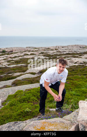 Thomas Sjögren, the 2015 Chef of the Year in Sweden and owner chef of Skäret Krog in Smögen foraging for food on Smögen's coastline, West Sweden. Stock Photo