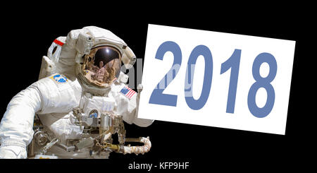 Astronaut in space holding a 2018 white  board - elements of this image are provided by NASA Stock Photo