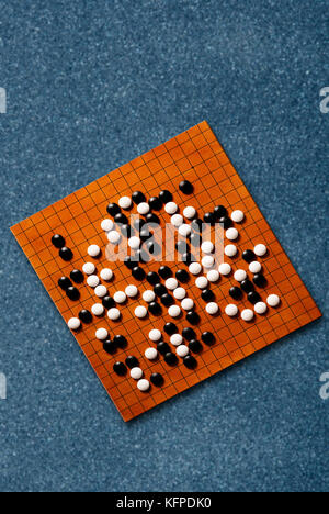 Goban with a Go game in progress, view from above Stock Photo