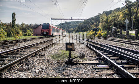 Serbia - Passenger train leaving the station Stock Photo