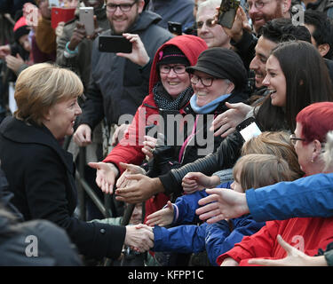 Wittenberg, Germany. 31st Oct, 2017. German Chancellor Angela Merkel (CDU, L) with members of the public, after a church service marking the 500th anniversary of the beginning of the Reformation, outside the Schlosskirche (Castle Church) in Wittenberg, Germany, 31 October 2017. Credit: dpa picture alliance/Alamy Live News Stock Photo