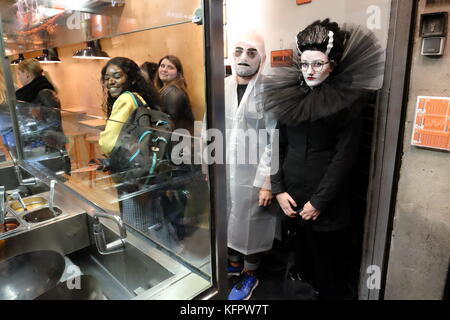 Barcelona, Spain. 31st Oct, 2017. A couple wearing Halloween costumes wait in a fast food restaurant. Joe O'Brien/Alamy Live News Stock Photo