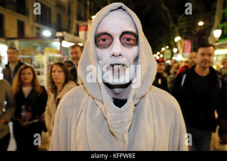 Barcelona, Spain. 31st Oct, 2017. A man with skeleton make up walks along La Rambla. Joe O'Brien/Alamy Live News Stock Photo