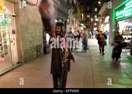 Barcelona, Spain. 31st Oct, 2017. A man wearing a pirate costume gestures to the camera. Joe O'Brien/Alamy Live News Stock Photo