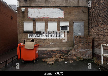 Private no parking at back of run down shop in Northwich Stock Photo